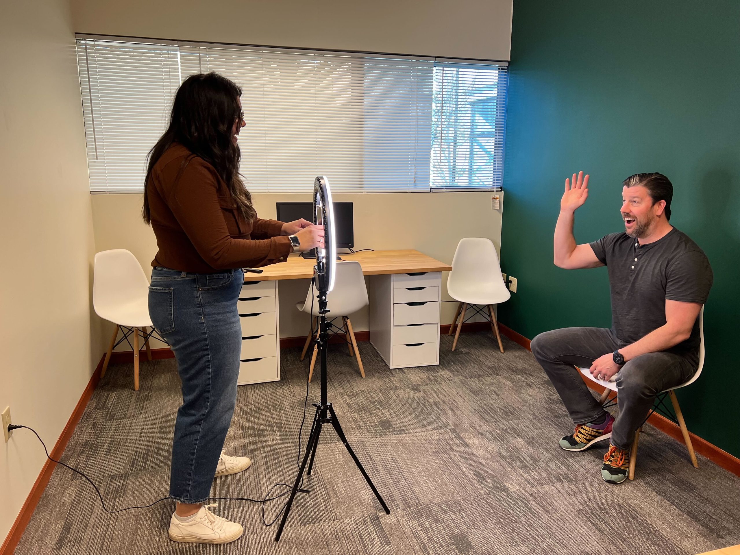Man waving at camera during an interview